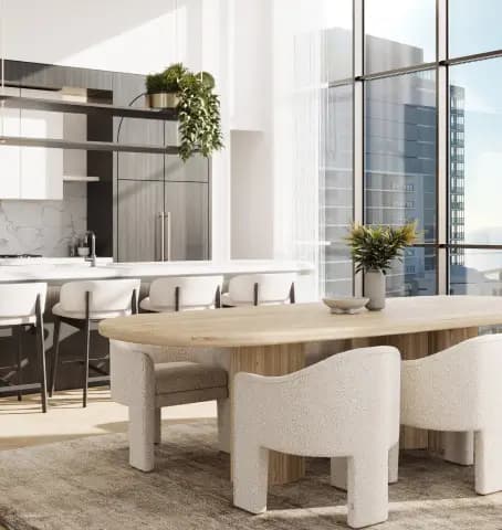 Bright dining area with a large wooden table and cushioned chairs, offering a stunning ocean view through floor-to-ceiling windows.