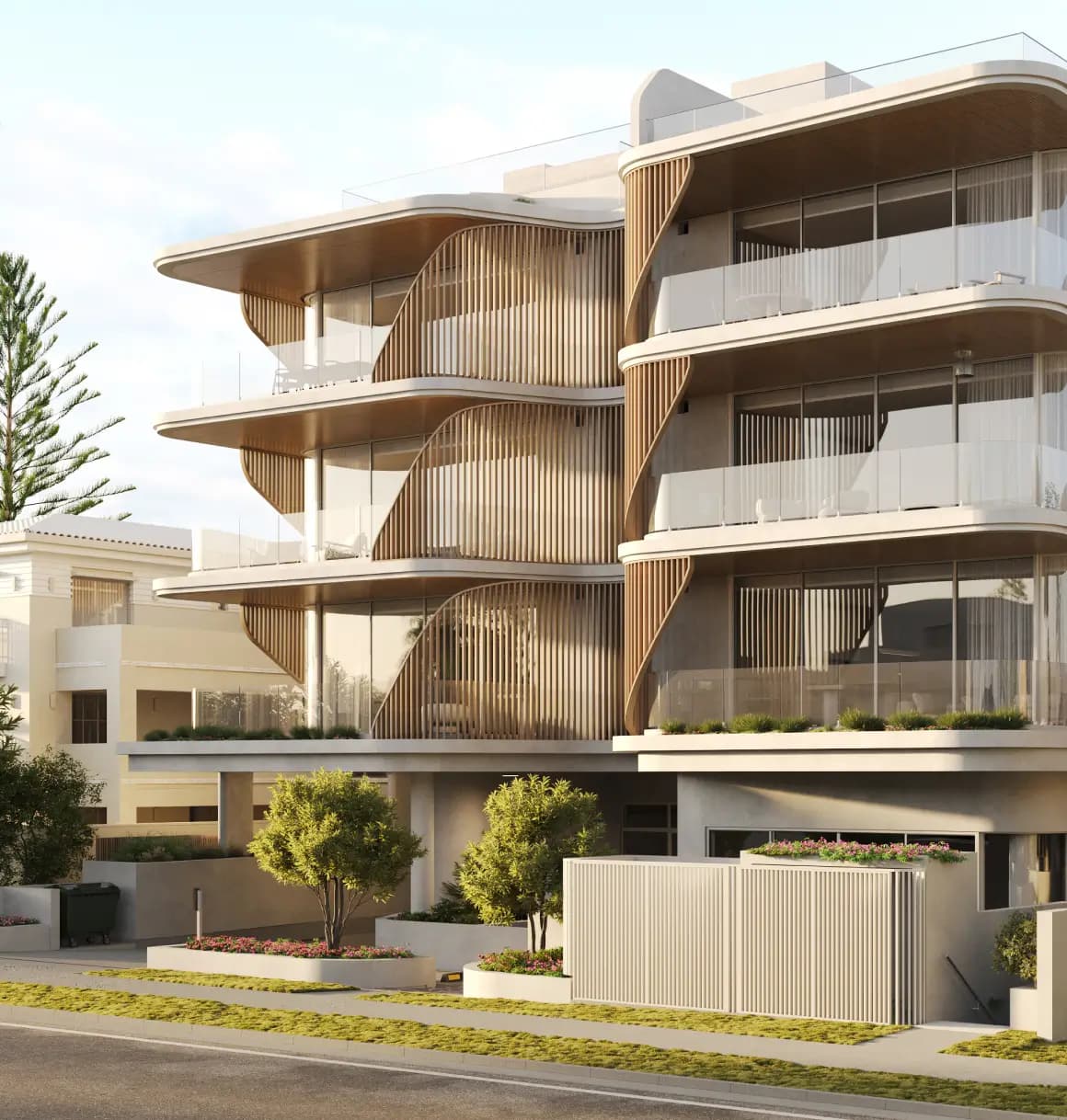 Street view of a modern multi-story building with a distinctive curved wooden facade, large glass windows, and lush landscaping, blending contemporary architecture with natural elements.