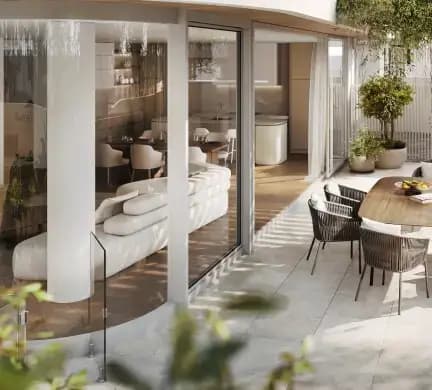 Stylish outdoor seating area with a modern design, featuring comfortable chairs, a wooden table, and lush greenery, perfect for relaxing and enjoying the fresh air.